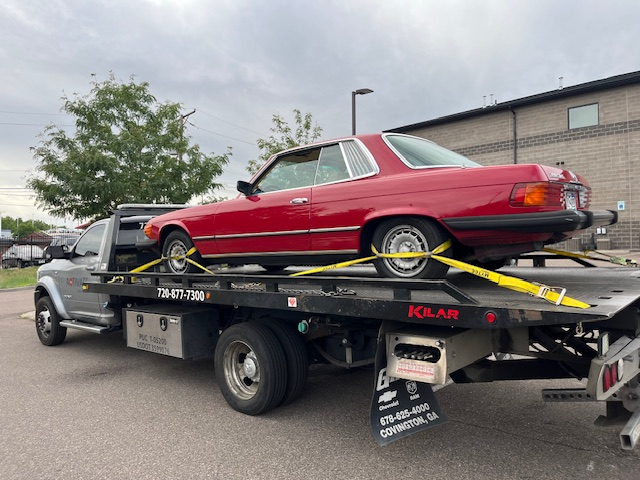 Activate Towing flatbed safely transporting a classic red Mercedes-Benz SLC — damage-free classic car towing